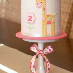 White Cake with Yellow Giraffe with Pink Spots and Pink and Yellow Flower
