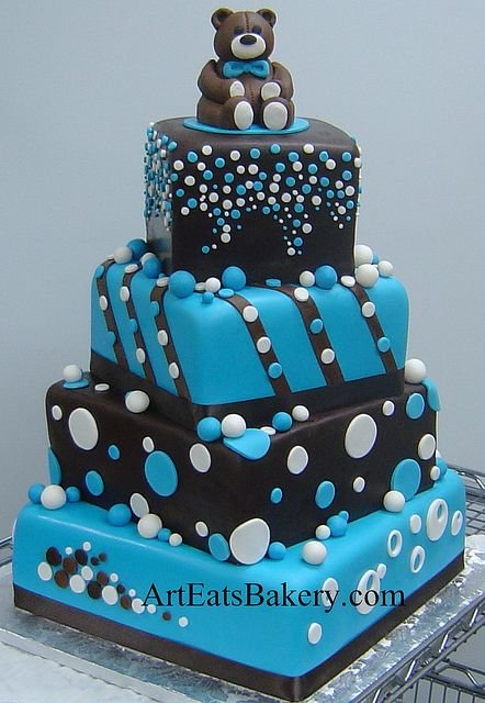Three tier chocolate brown and blue polka dot cake with edible teddy bear topper
